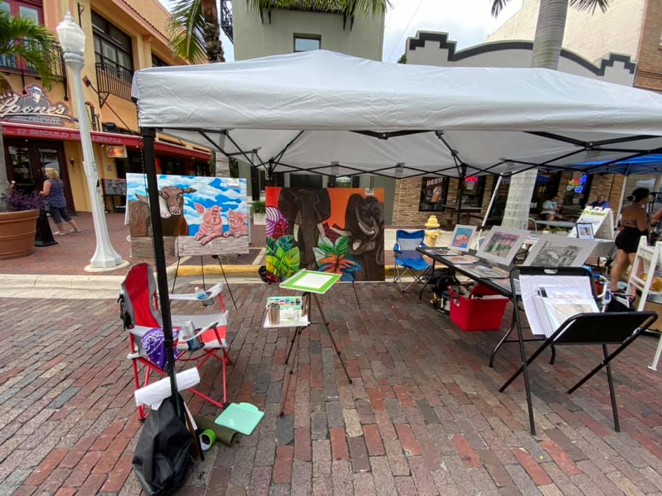 Tent with a table and art on the table.